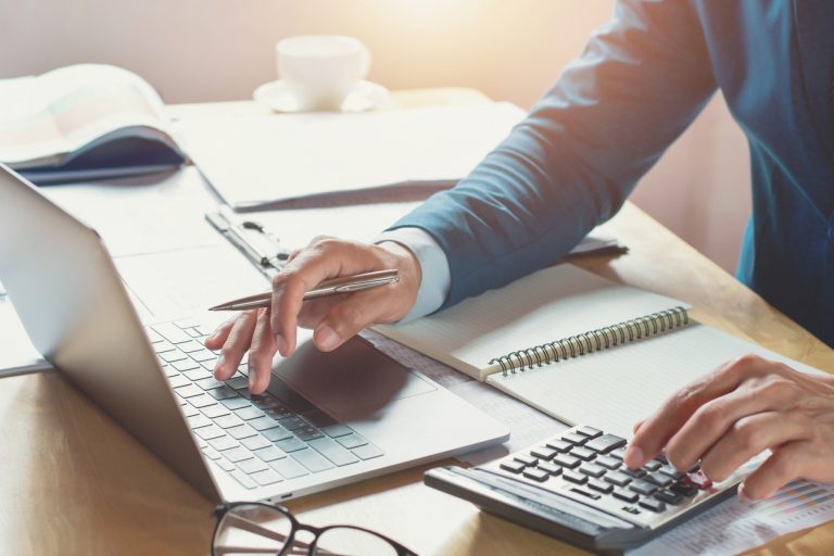 businessman working in office with using calculator and laptop
