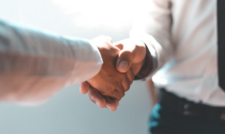 Men and women negotiate to congratulate a successful business ,Shaking hands concept