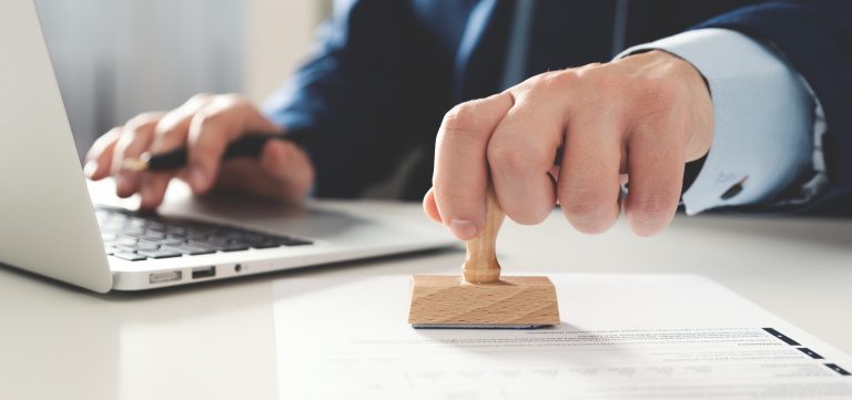 Businessman working in office with stamp